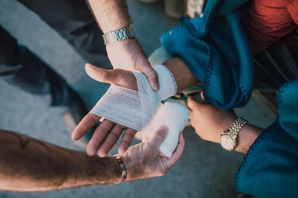 Wrapping a customers hand with Gauze from a stocked first aid kit