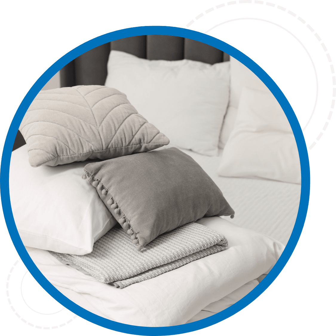 Cleaned bedding including blankets and pillow cases stacked on a bed
