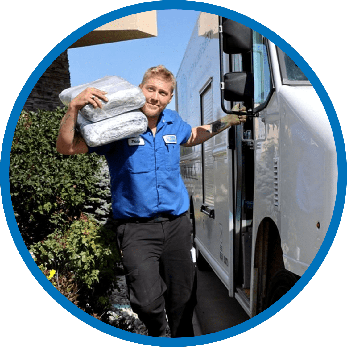 Severall employee exiting delivery van carrying uniforms on his shoulder.