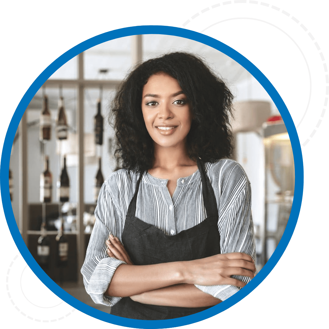 Smiling woman wearing a black apron in a resturant