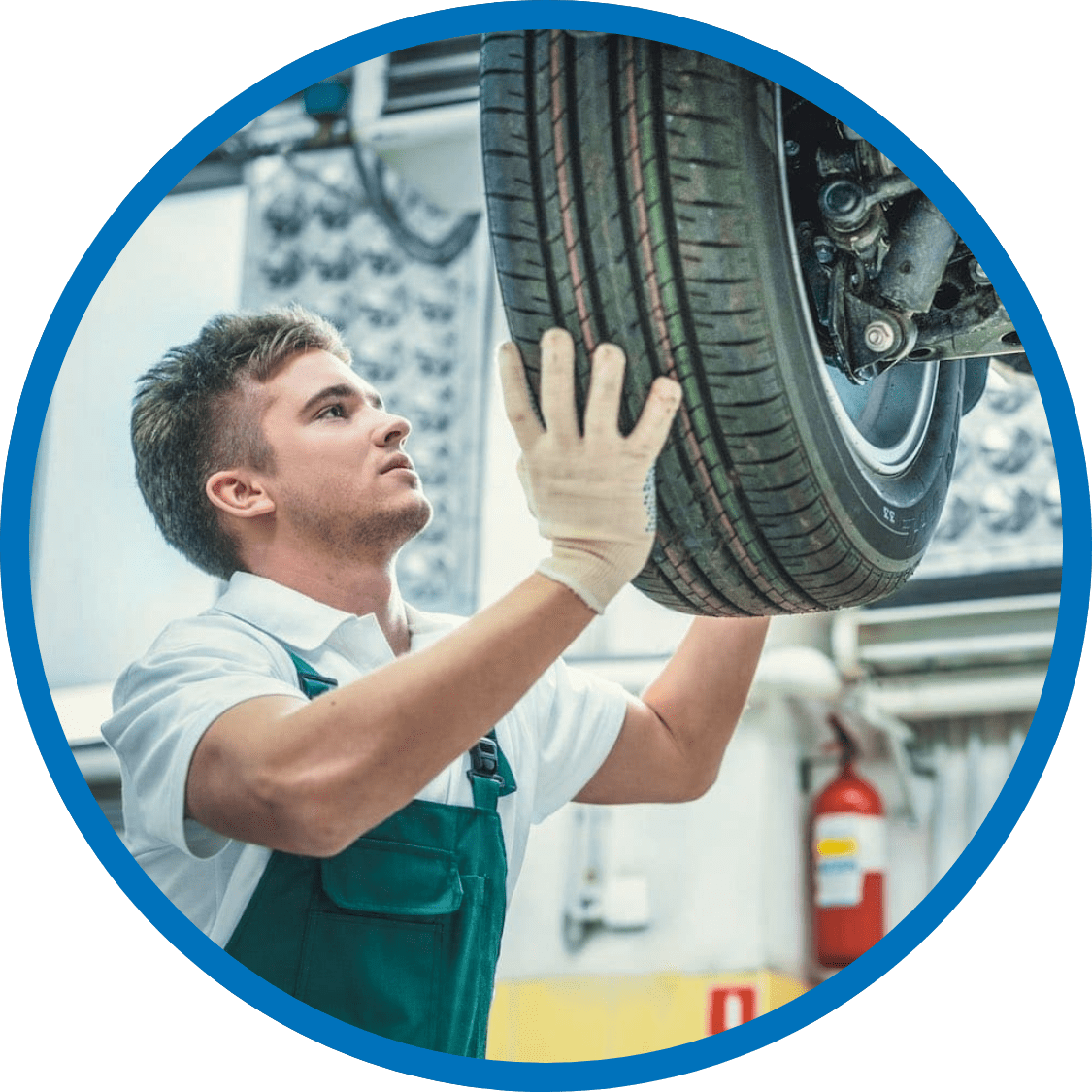 Technician wearing a clean uniform installing a tire on a vehicle