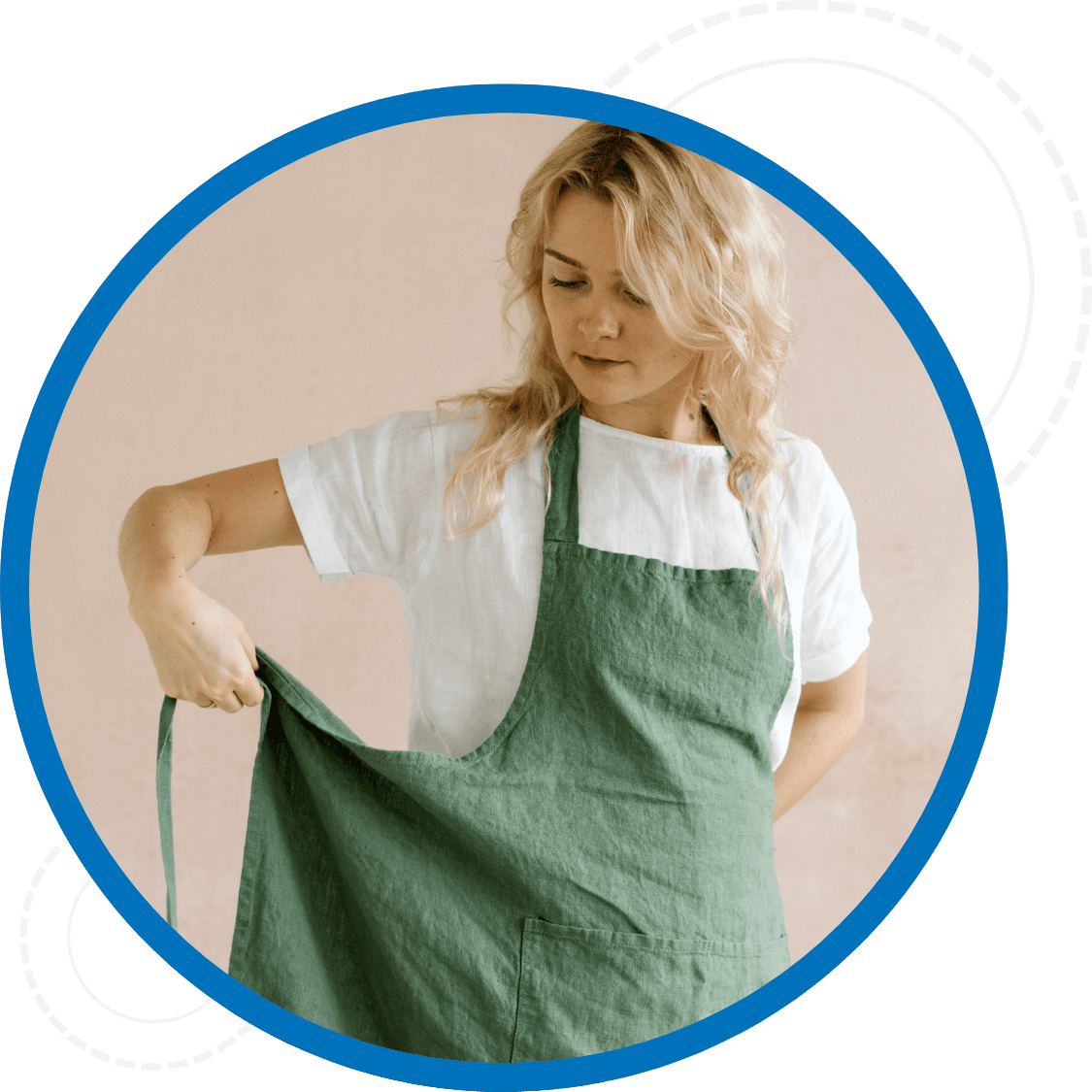 Woman putting on a clean green apron