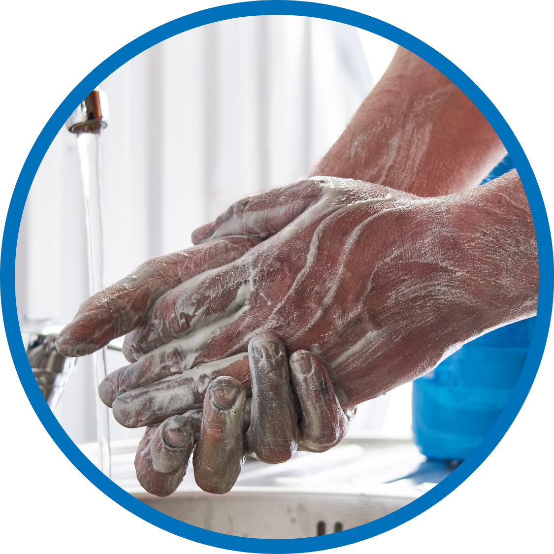 Mechanic washing the oil from his hands