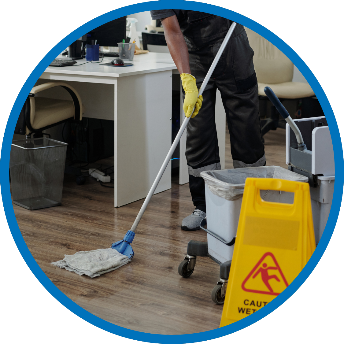 Janitor mopping floors in an office space after hours