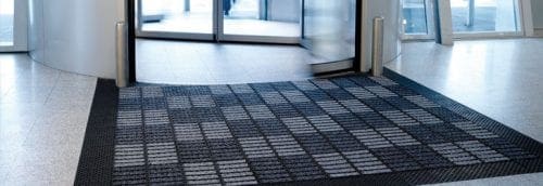 Servall industrial floor mat in front of revolving door