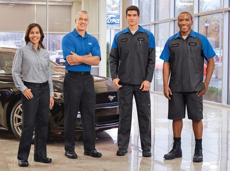 Uniformed employees in front of ford mustang