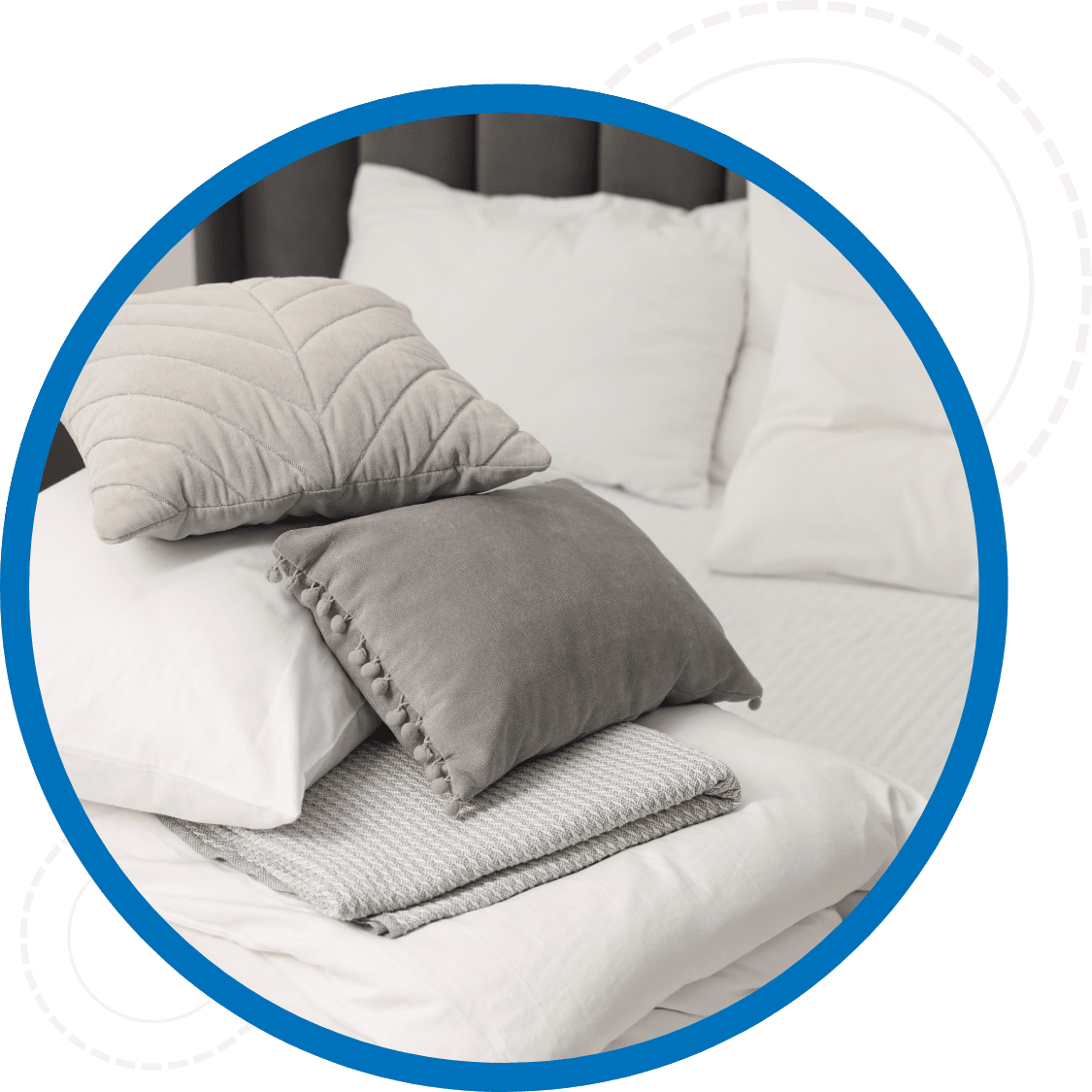 Cleaned bedding including blankets and pillow cases stacked on a bed