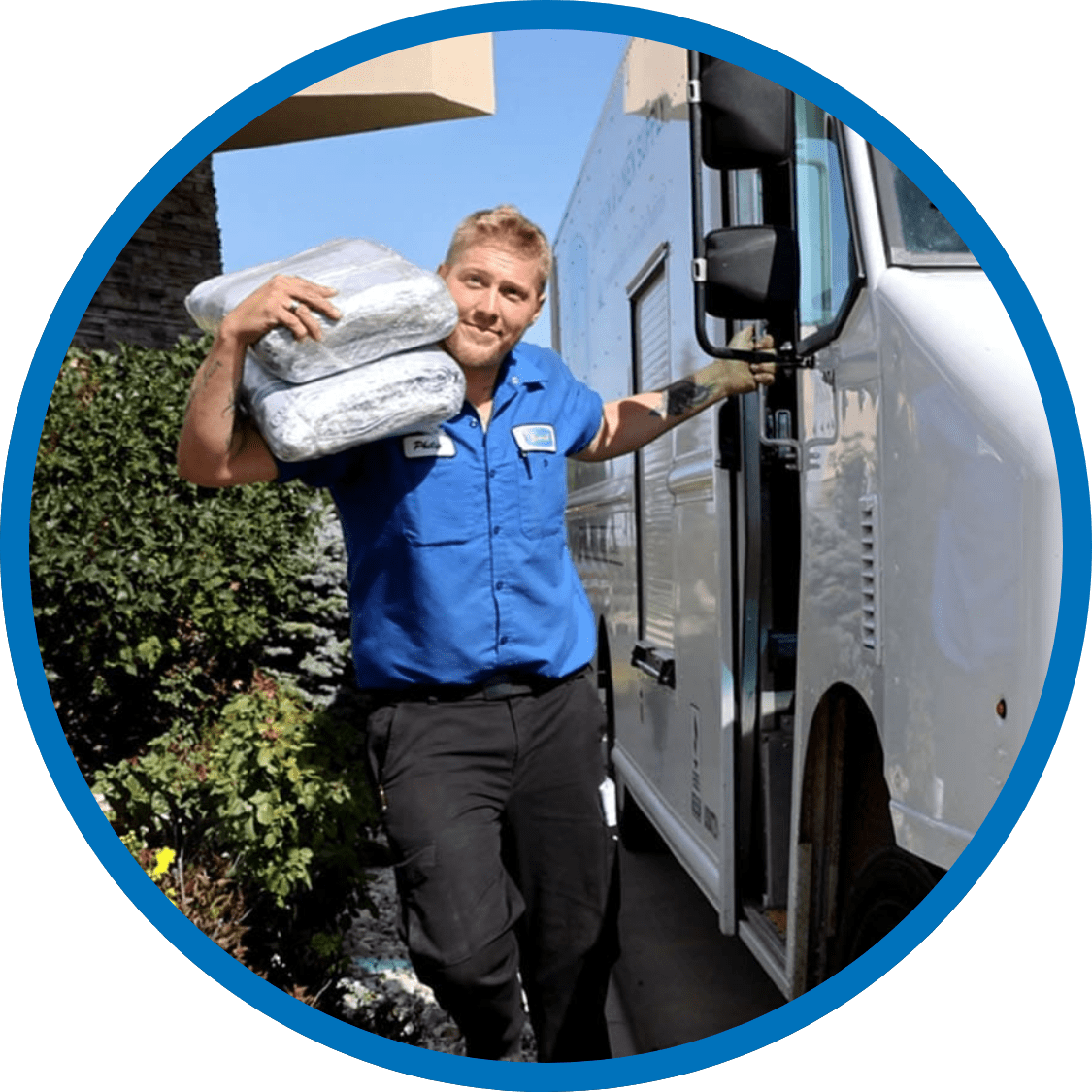 Severall employee exiting delivery van carrying uniforms on his shoulder.