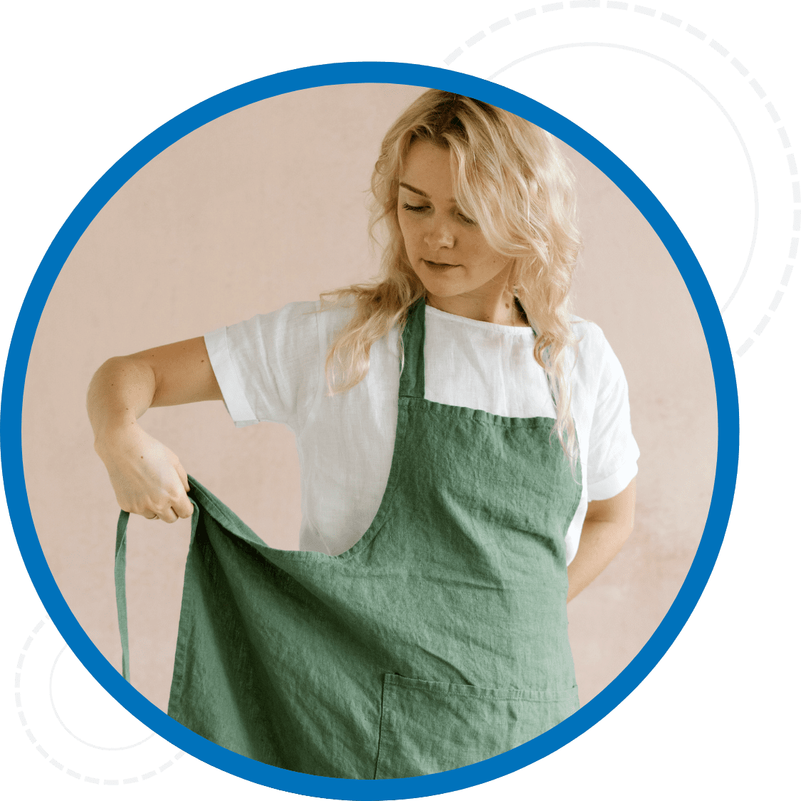 Woman putting on a clean green apron